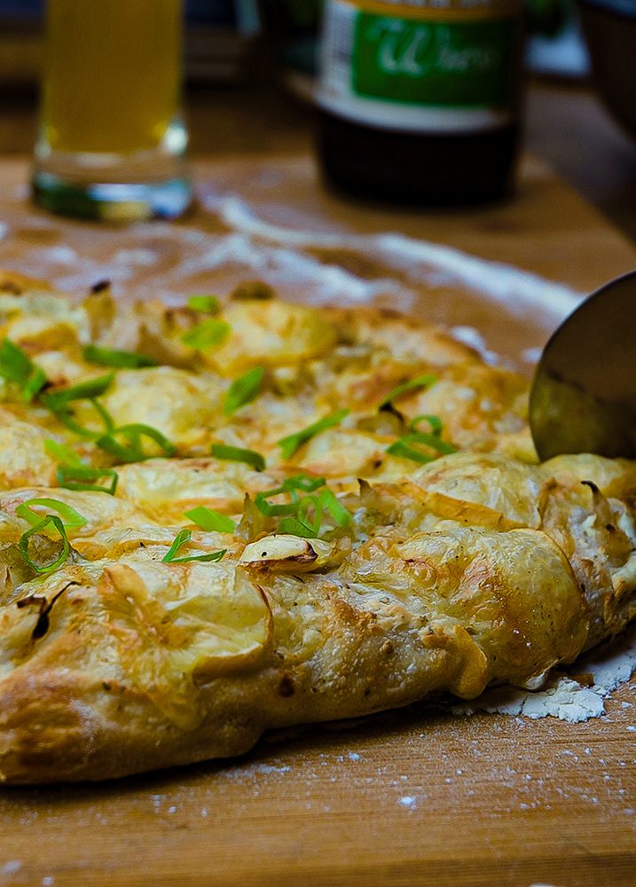 Sauerkraut Pizza wird angeschnitten